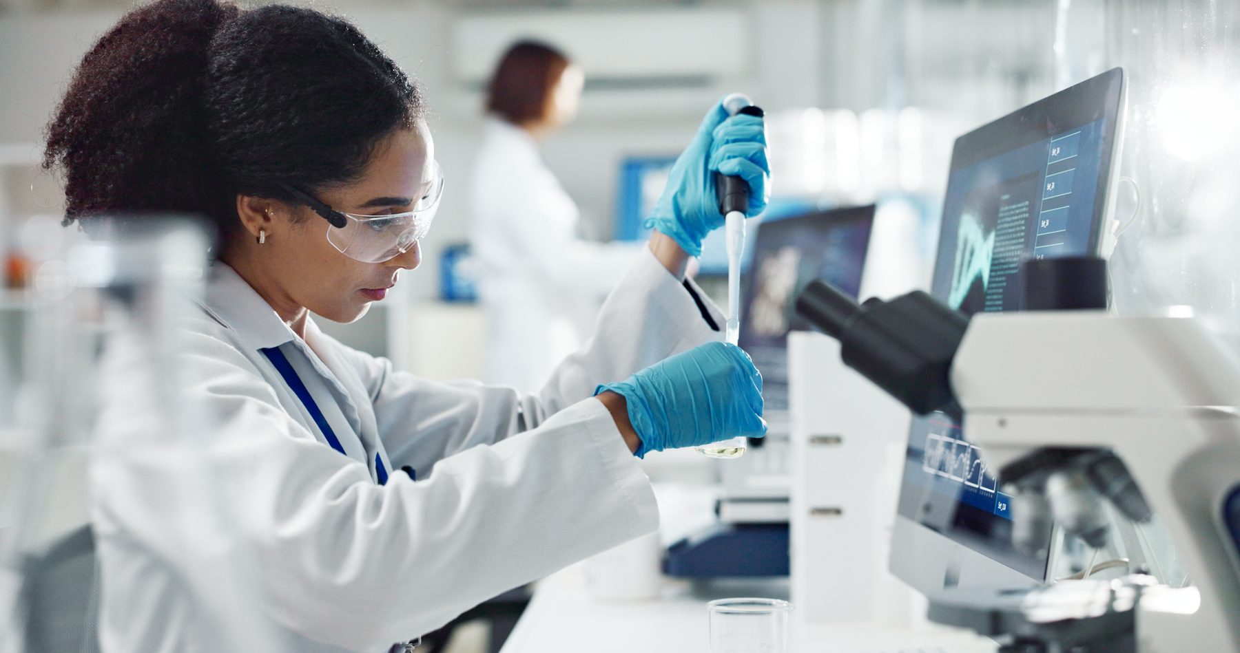A scientist pipetting a sample in a laboratory